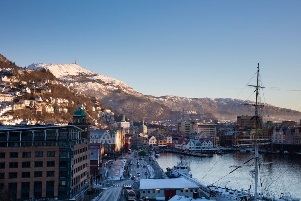 A great view of Bergen harbor, with a tall ship in the foreground.