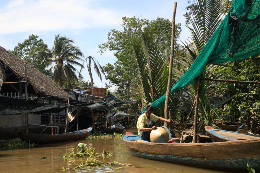 This man working on a boat is very typical of the Mekong Delta.