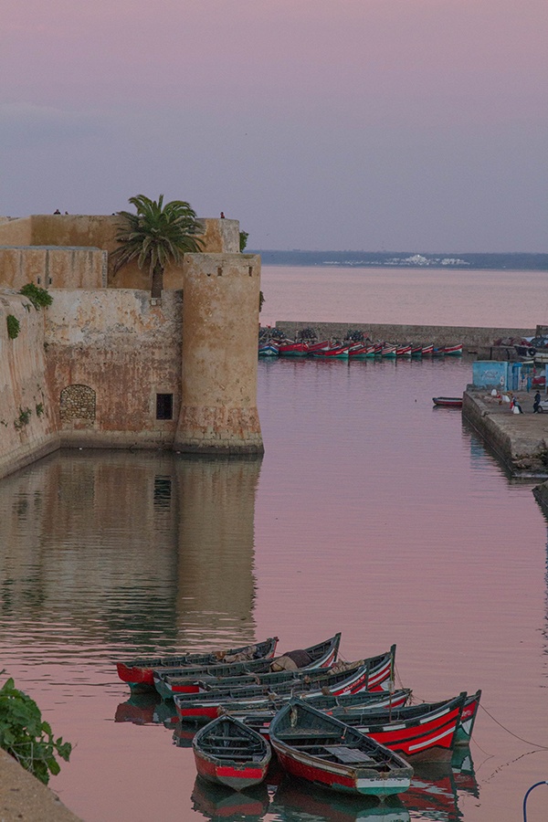 Red fishing boats anchored in the harbor in El Jadida, a UNESCO World Heritage Site.