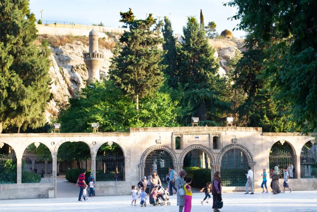 Tourists and locals walking and talking near the Urfa Kale.