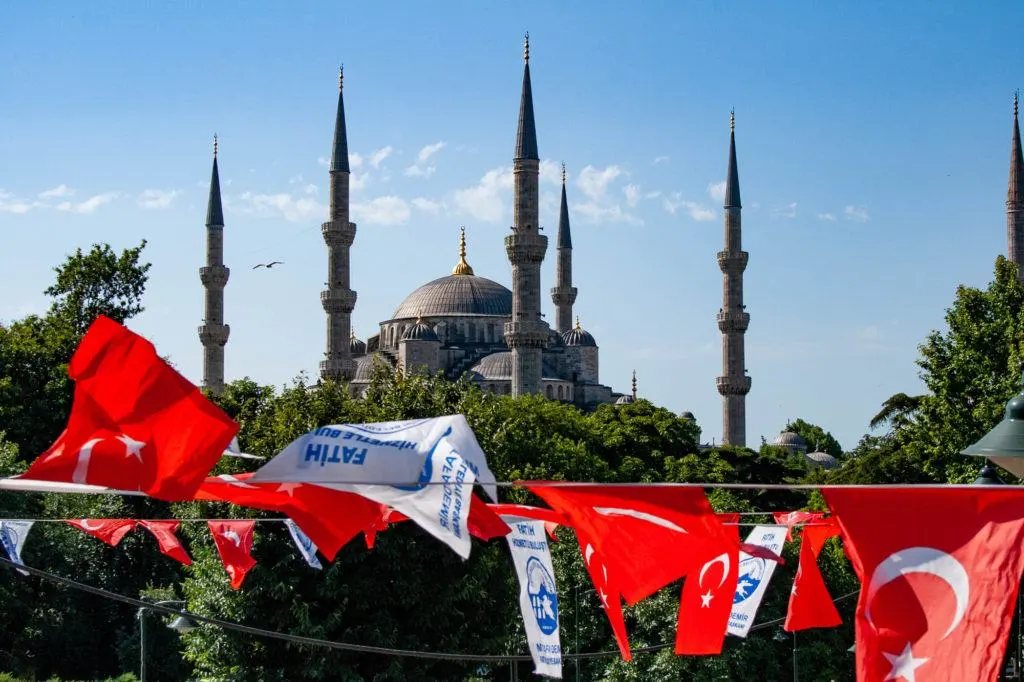 Blue Mosque with Turkish banners in front, some flags.