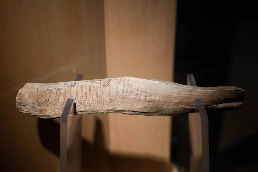Artifacts, like this ancient rune stick, are among the cool things to see on a rainy day when visiting Bergen in winter.