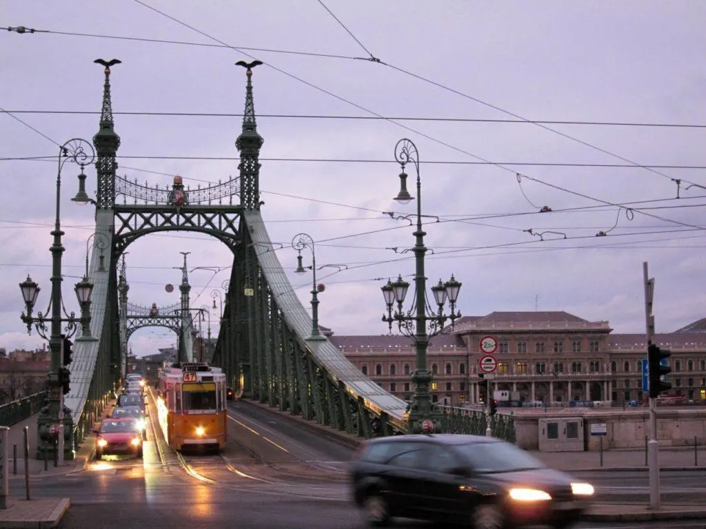 Tram and cars crossing the Danube in this city.