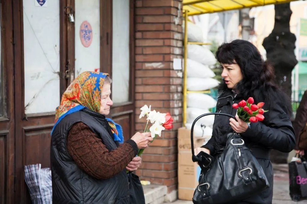 Two women chatting with flowers in Bulgaria. 