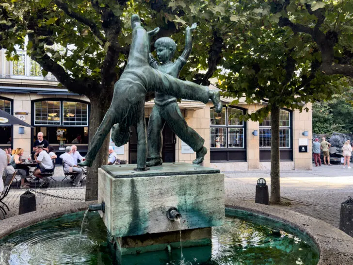 Cartwheel statue in a quaint square in Düsseldorf, perfect place to sit on a weekend trip.