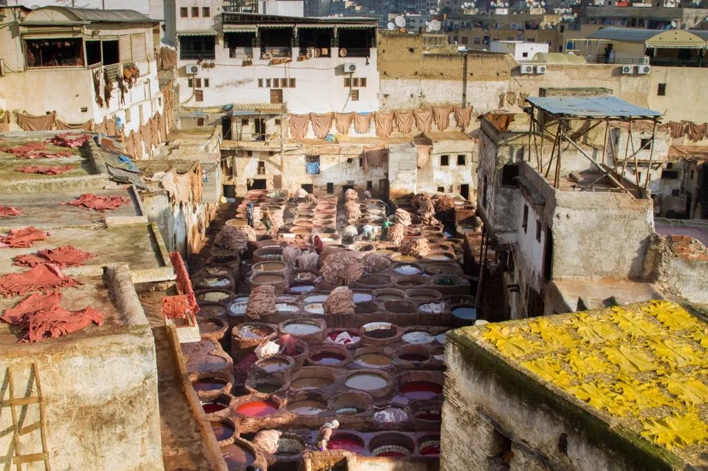 What a stunning scene with red and yellow skins drying on the roof tops and in between an area with at least 100 tannery pots.