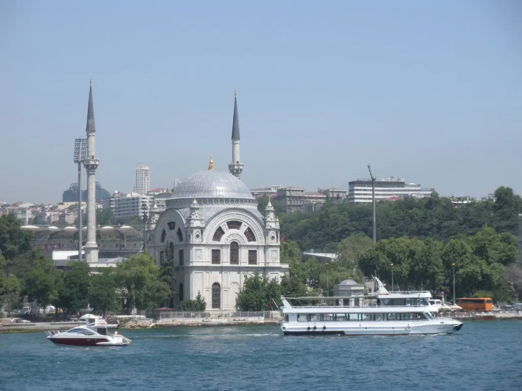 Dolmabahce Palace from the water. Boats are in front of it.