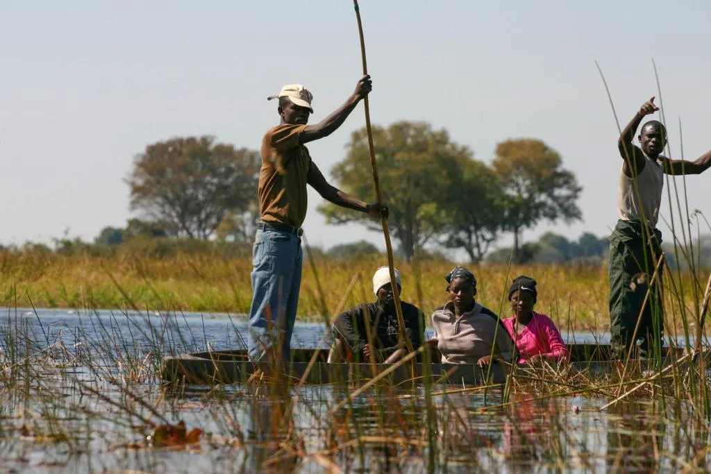 A group of locals poling in the Okavango Delta, a UNESCO World Heritage Site.