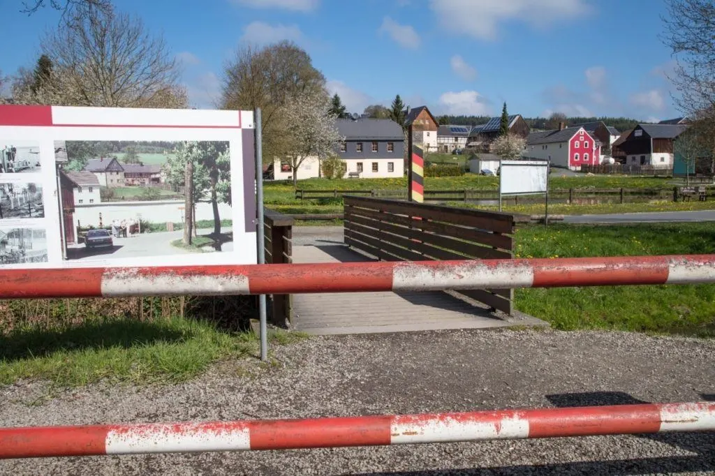 The guarded gate and a sign showing the town as it was in the 1940s.