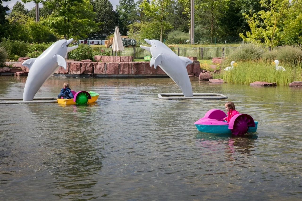 The lake has small boats for the kids to propel on their own.
