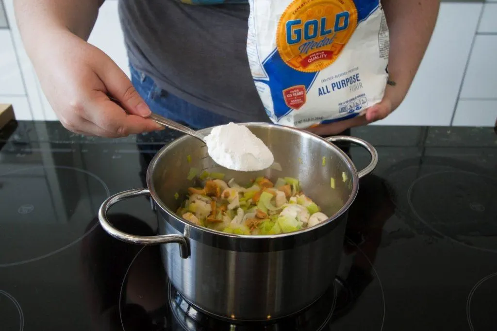 Adding flour to thicken.