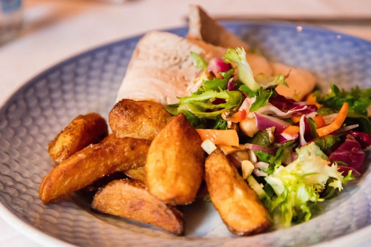 The food in Sweden we ate is hearty, like this plate of fried potatoes, fish, and fresh salad.