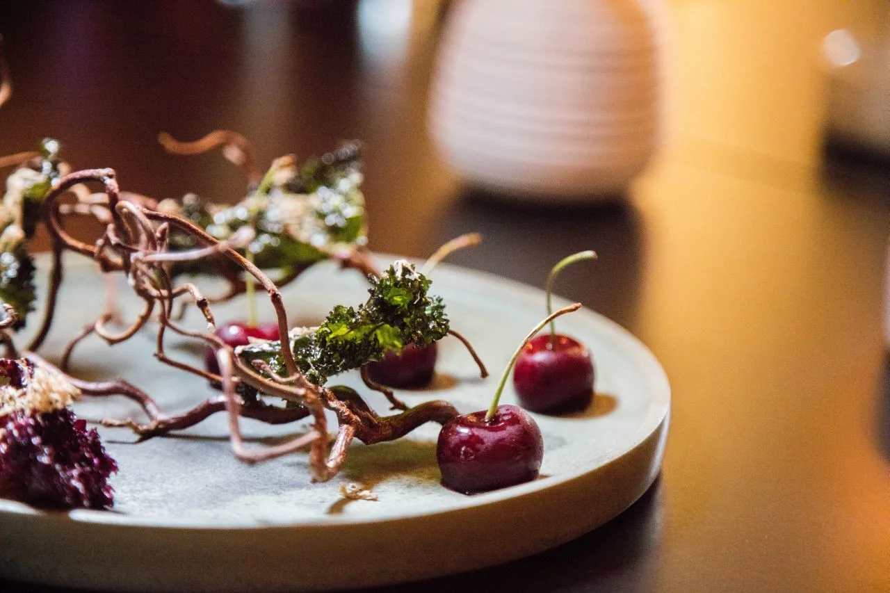 Foie gras stuffed cherries with crispy kale chips.