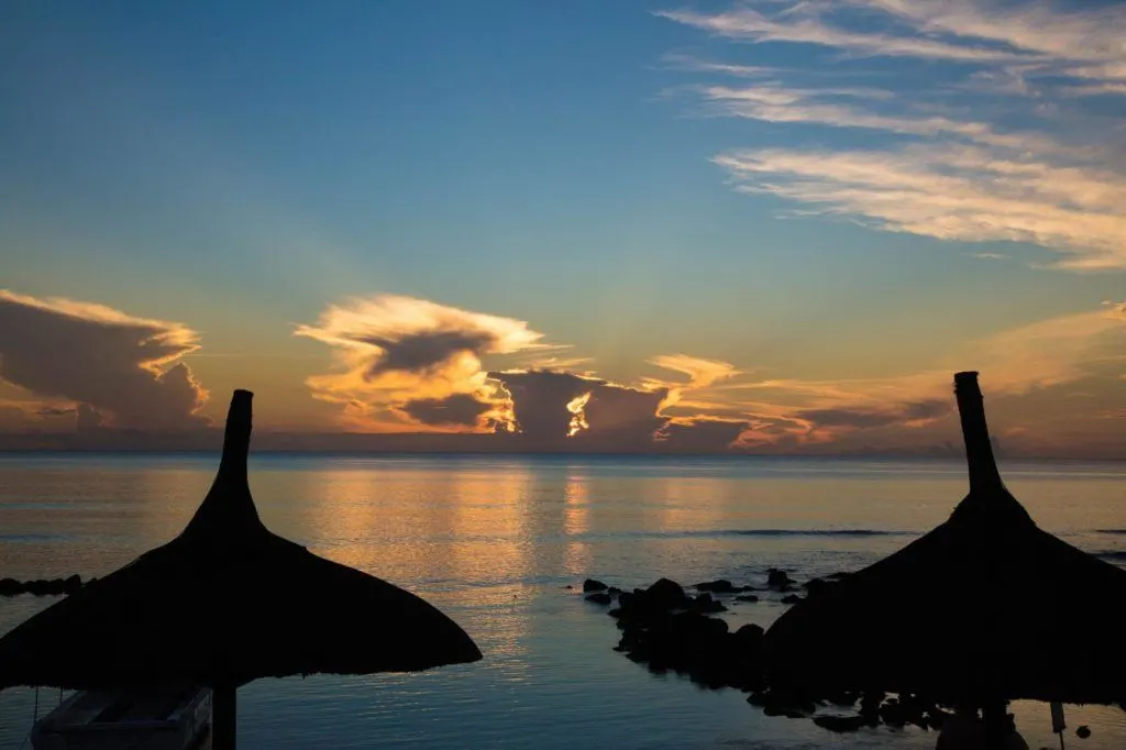Sunset through the beach umbrellas of our resort.