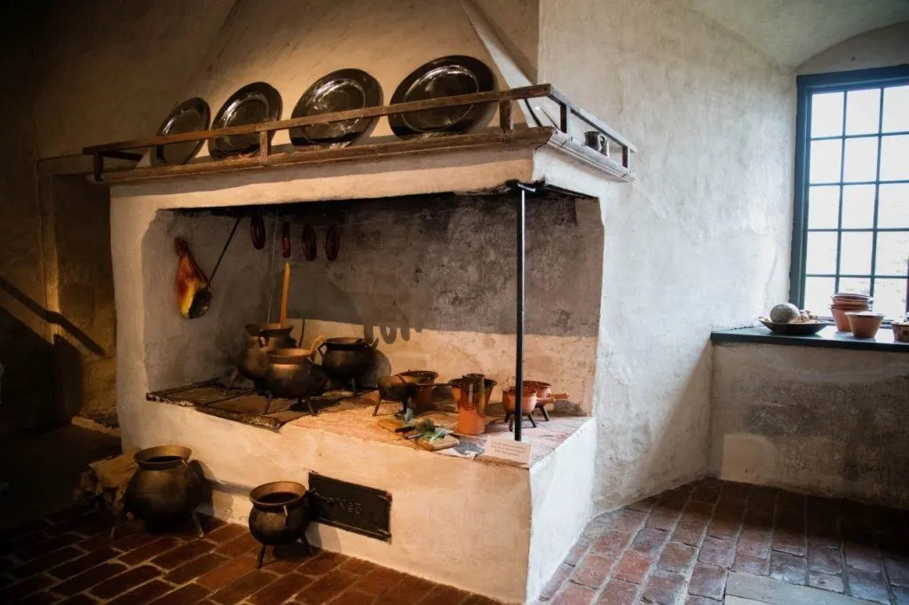 Kalmar castle kitchen with old pots, pans, and stove.