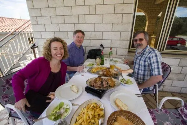 Dinner is served, roast lamb, roast pork, salad, and fries.