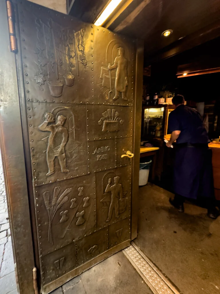 Peeking in through the heavy copper door of Uerige brewery in Düsseldorf.
