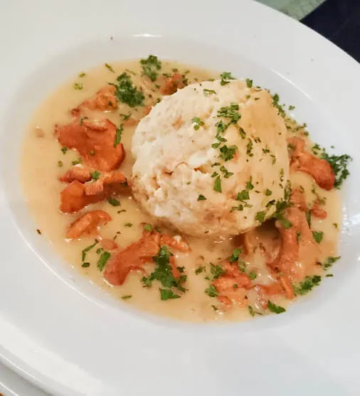 Vegetarian Dish of mushrooms and dumpling with sauce.