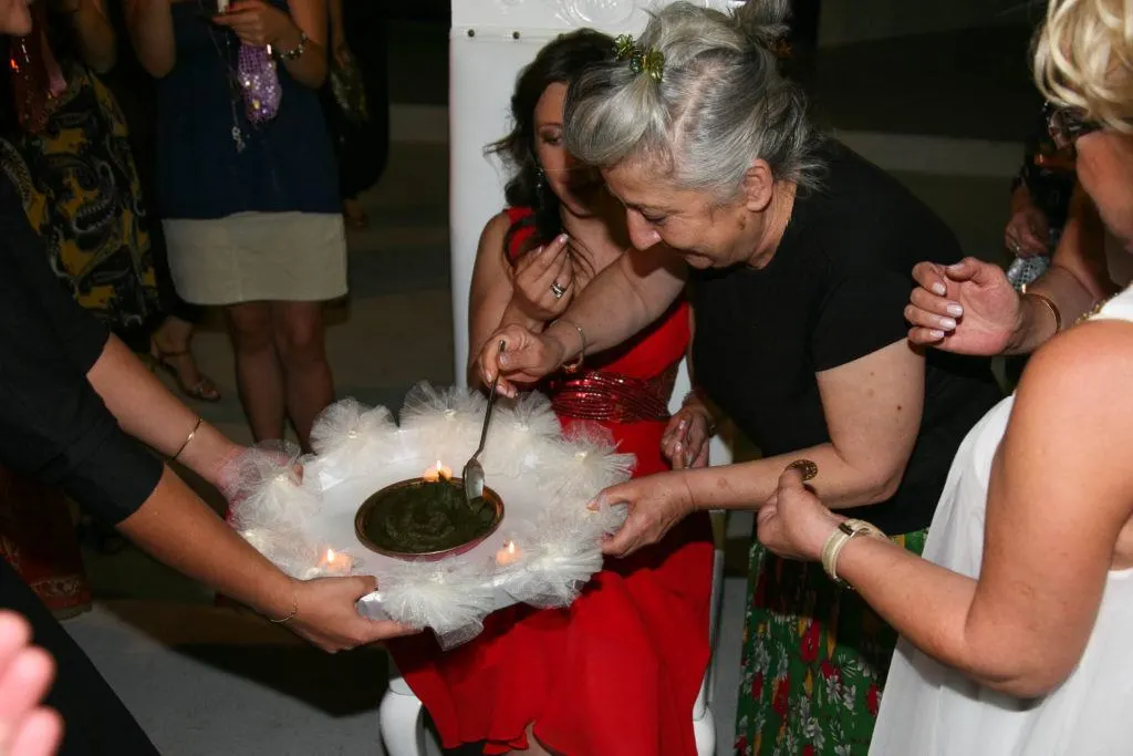 A bride-to-be at a henna party is receiving Turkish henna for good luck.